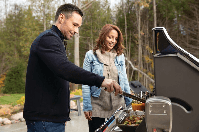 man and woman using a Prestige propane grill